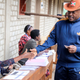 Burundi President Pierre Nkurunziza is registered by an electoral official before voting on a constitutional amendment referendum in Ngozi province, northern Burundi, May 17, 2018.